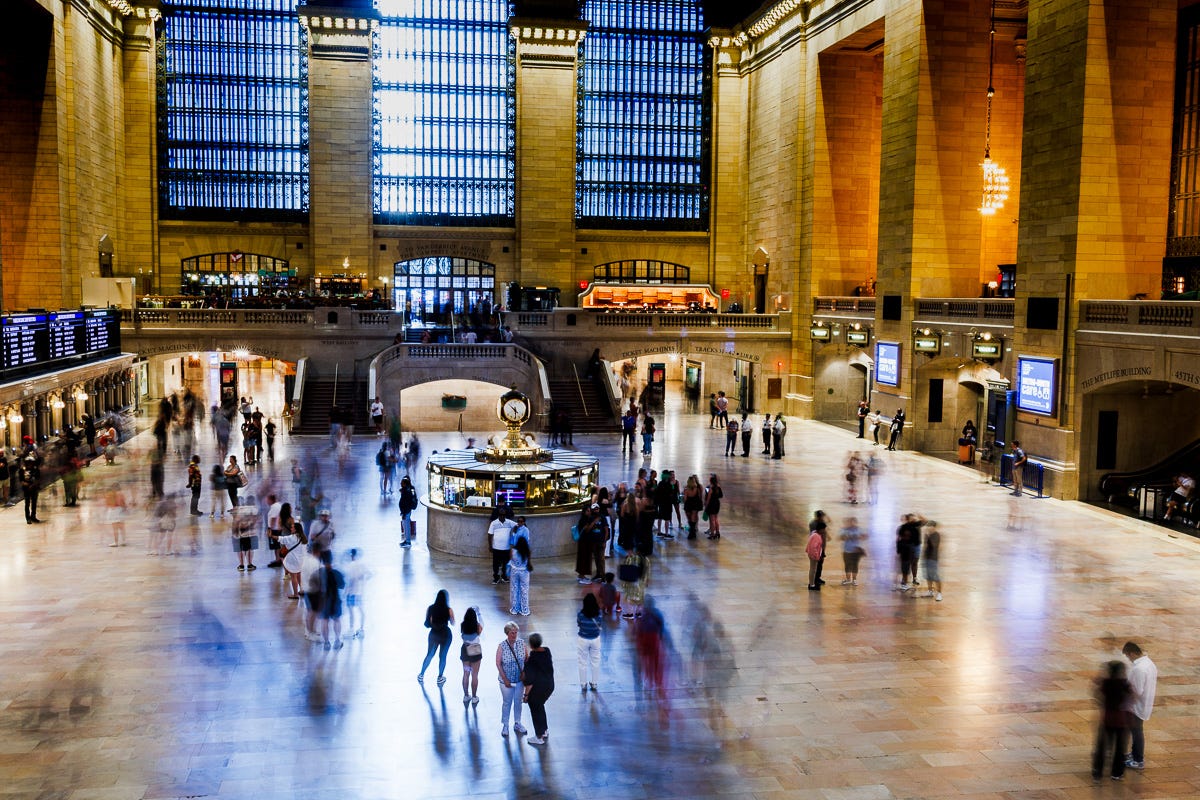Long exposure photo at New York Grand Central Station with blurred commuters and bright hall windows Long exposure photo at New York Grand Central Station with blurred commuters and bright hall windows