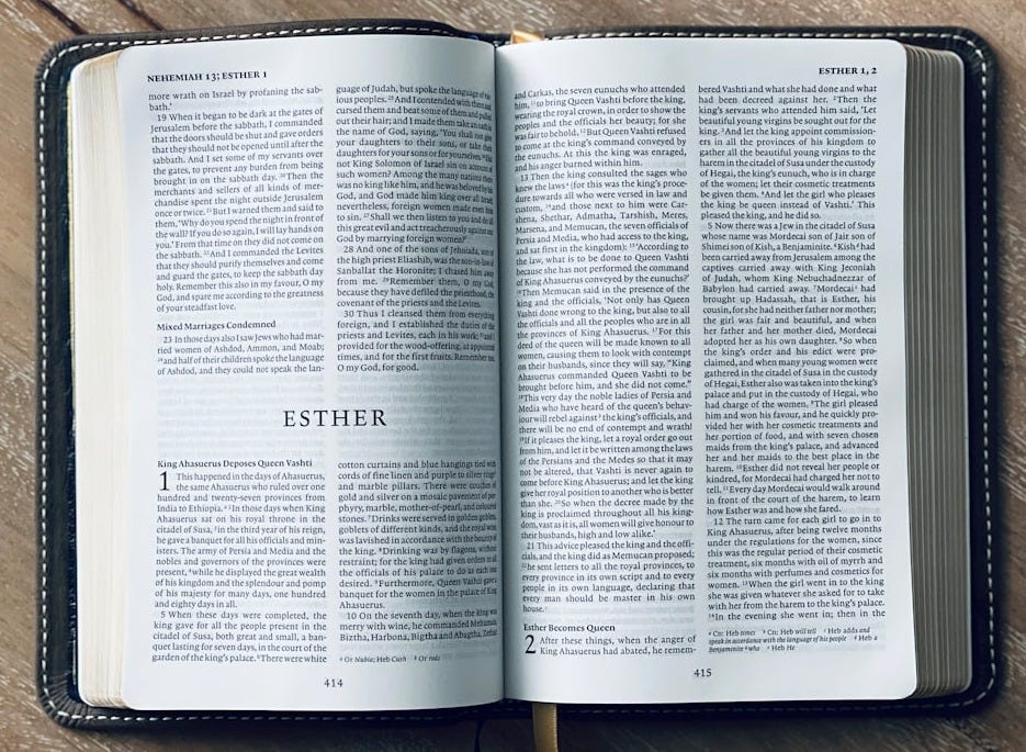 an open book sitting on top of a wooden table an open book sitting on top of a wooden table