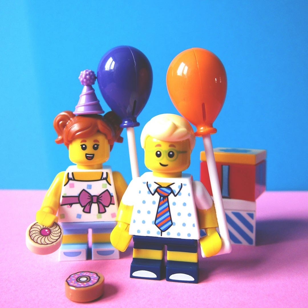 girl and boy holding balloon Lego minifugures