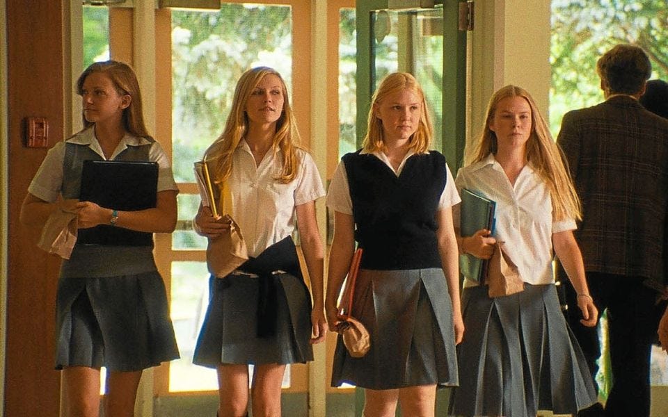 The Lisbon sisters arriving at school, walking side-by-side.
