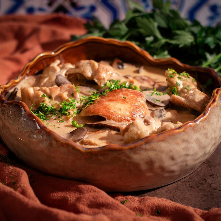 A bowl of creamy chicken stew with mushrooms and dark chocolate brownies topped with ice cream and hot fudge.