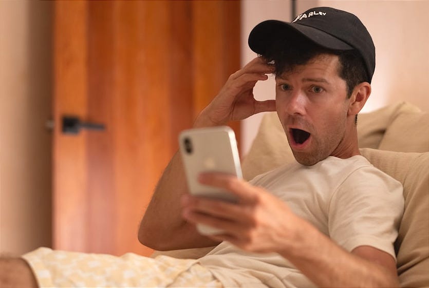 Man is shocked looking at his phone.