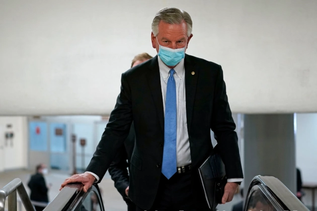 Sen. Tommy Tuberville (R-Ala.) rides an escalator on Capitol Hill as he heads to the second day of the second impeachment trial of former President Donald Trump.