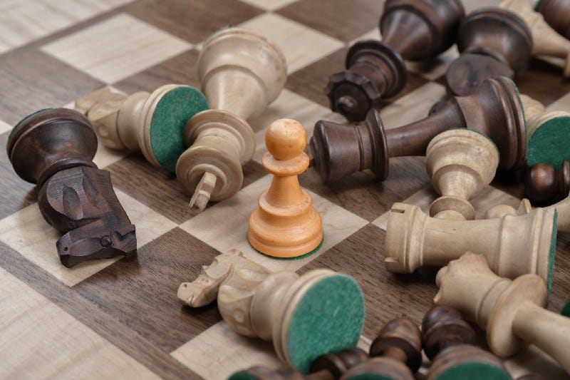 A chess table with all pieces down besides a pawn A chess table with all pieces down besides a pawn