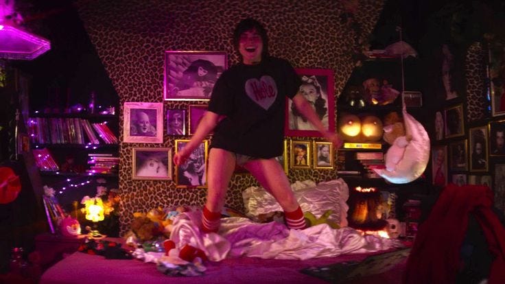 This may contain: a man standing on top of a bed in a room filled with pictures and other items