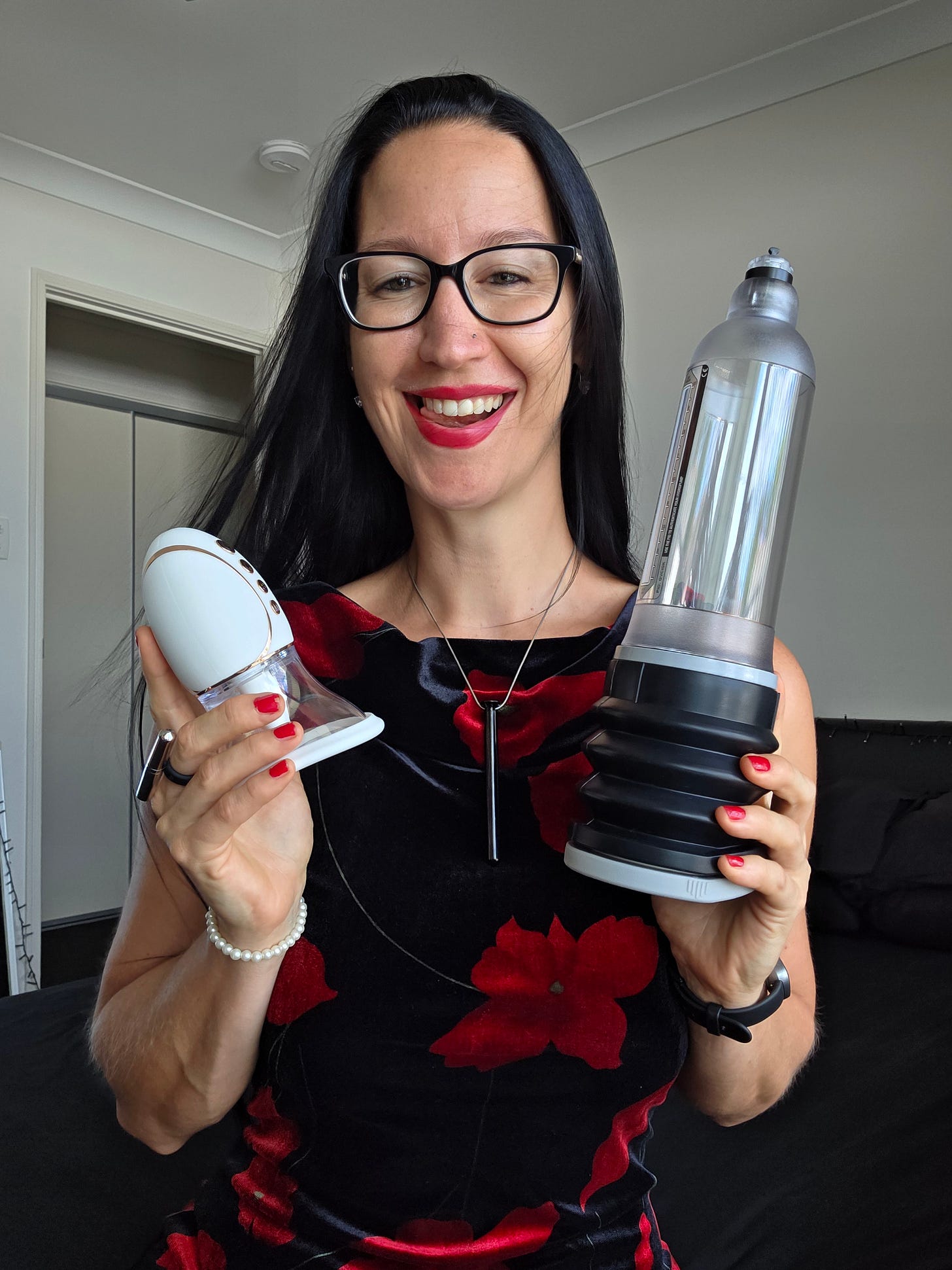 Pleasurelit Patricia holding a penis pump and vulva pump