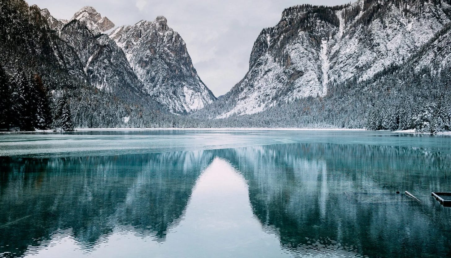 A mountain pass reflected in water