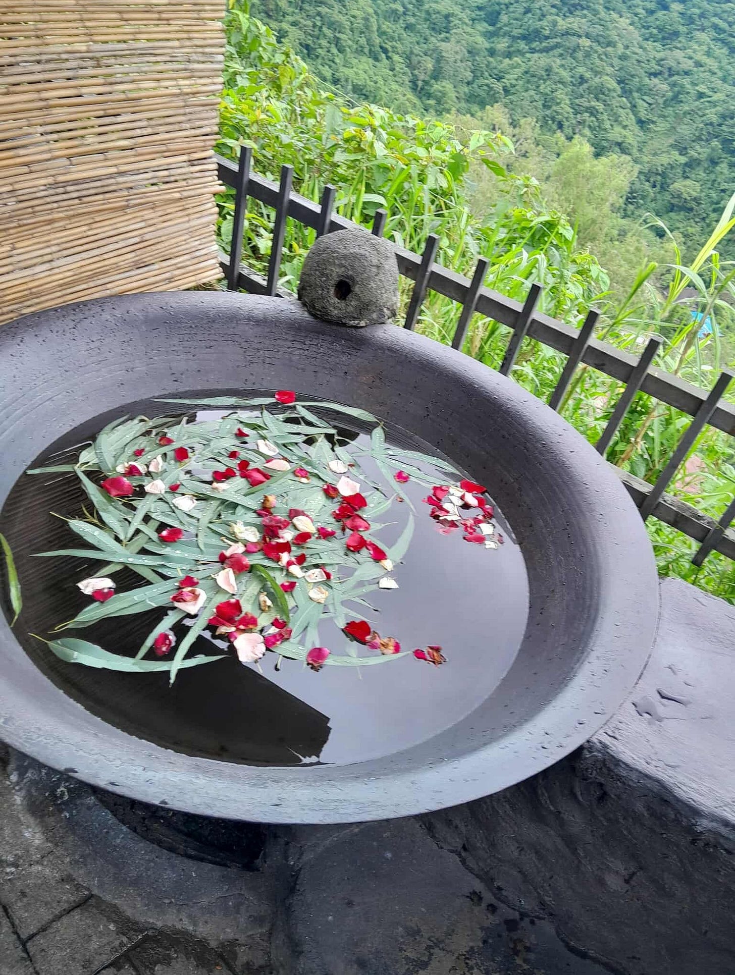 A kawa filled with water, eucalyptus leaves, and rose petals.