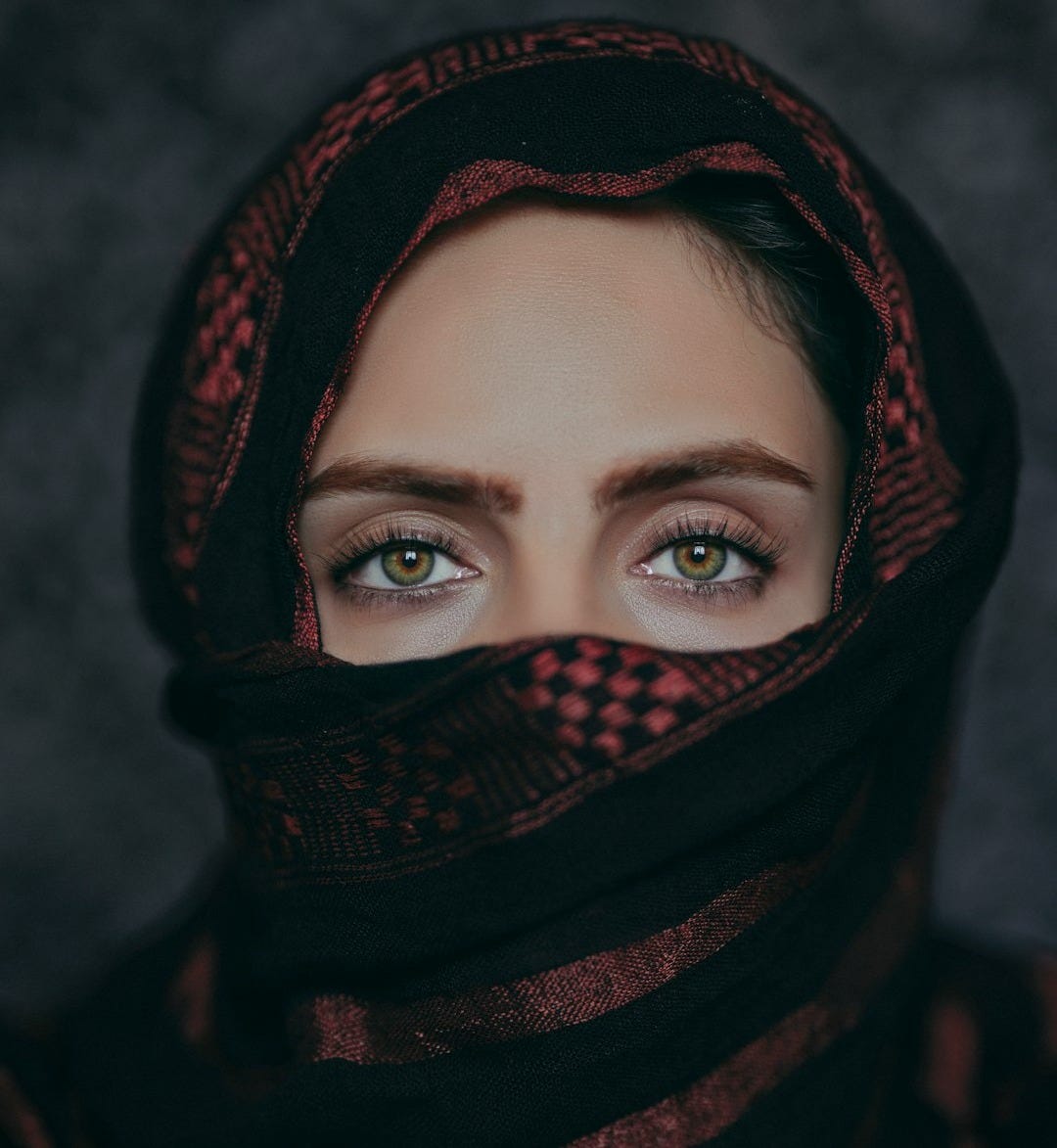 a woman wearing a black and red scarf