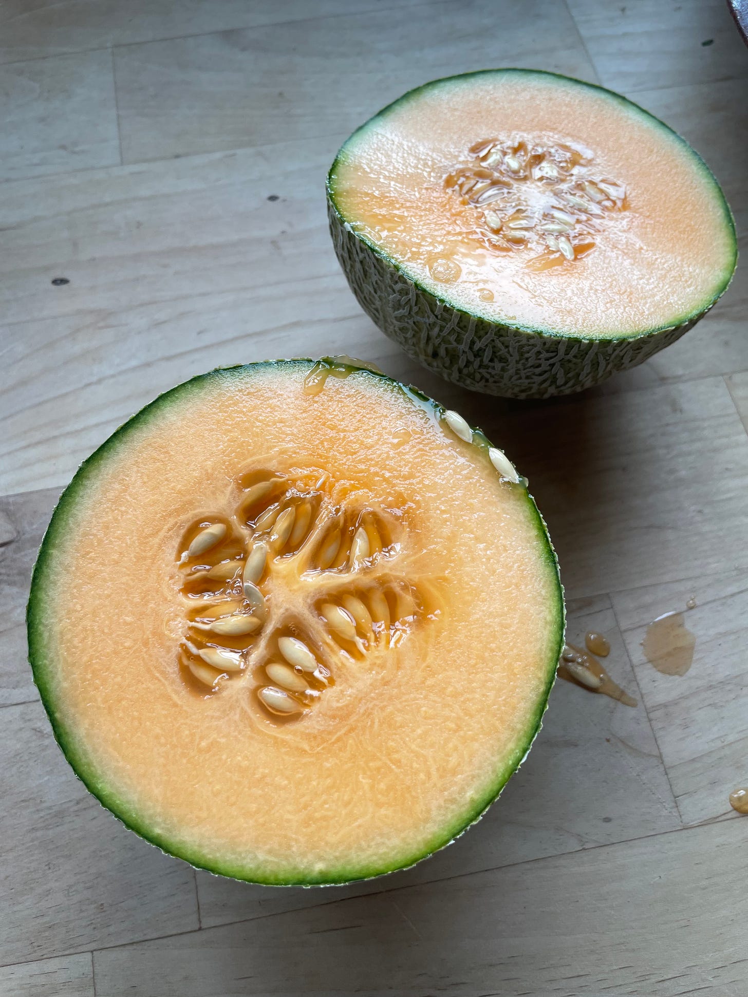 a cut cantaloupe with seeds