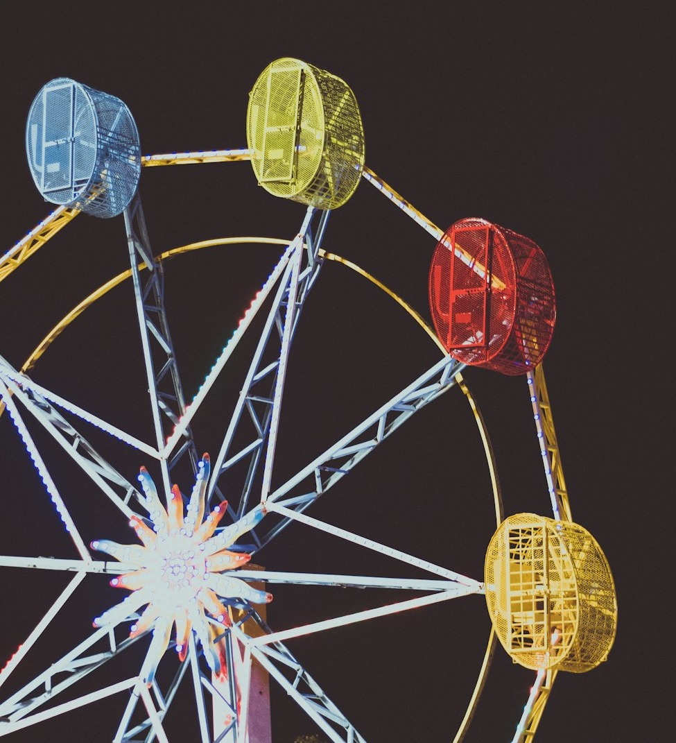 a ferris wheel lit up in the night sky a ferris wheel lit up in the night sky