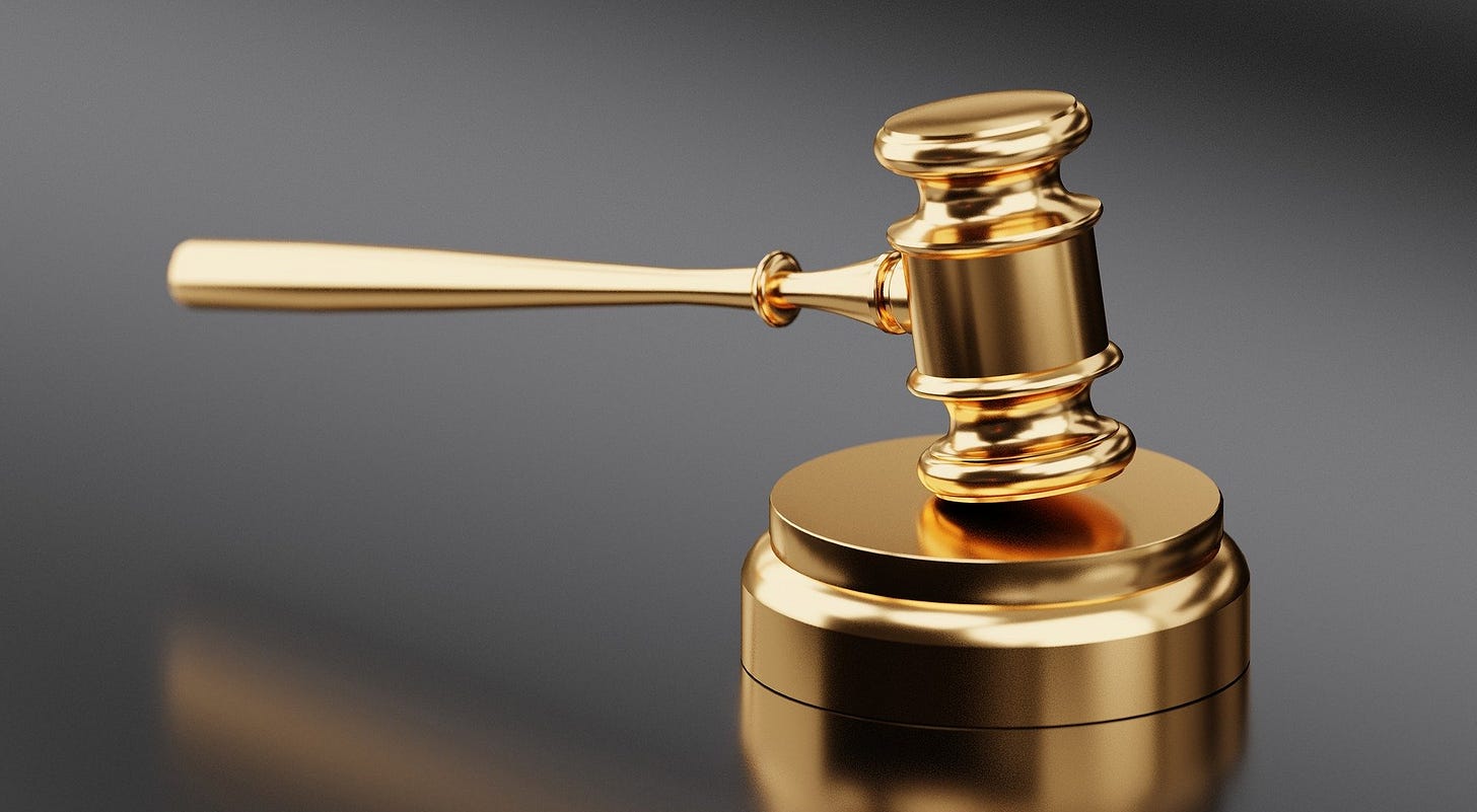 A golden gavel hitting on a golden gavel pad. A golden gavel hitting on a golden gavel pad.