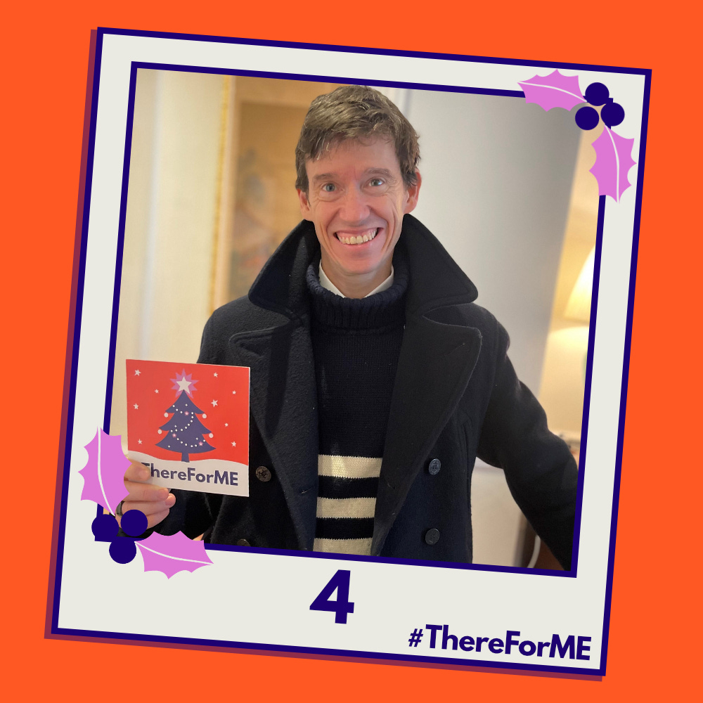 A pretend polaroid shows a smiling Rory Stewart posing for a photo holding a #ThereForME Christmas card.   The image on the card shows the dark blue Christmas tree, decorated with sparkling fairy lights, baubles and a star on the top, in a snowy landscape against a starry backdrop. The design is in the #ThereForME colours.