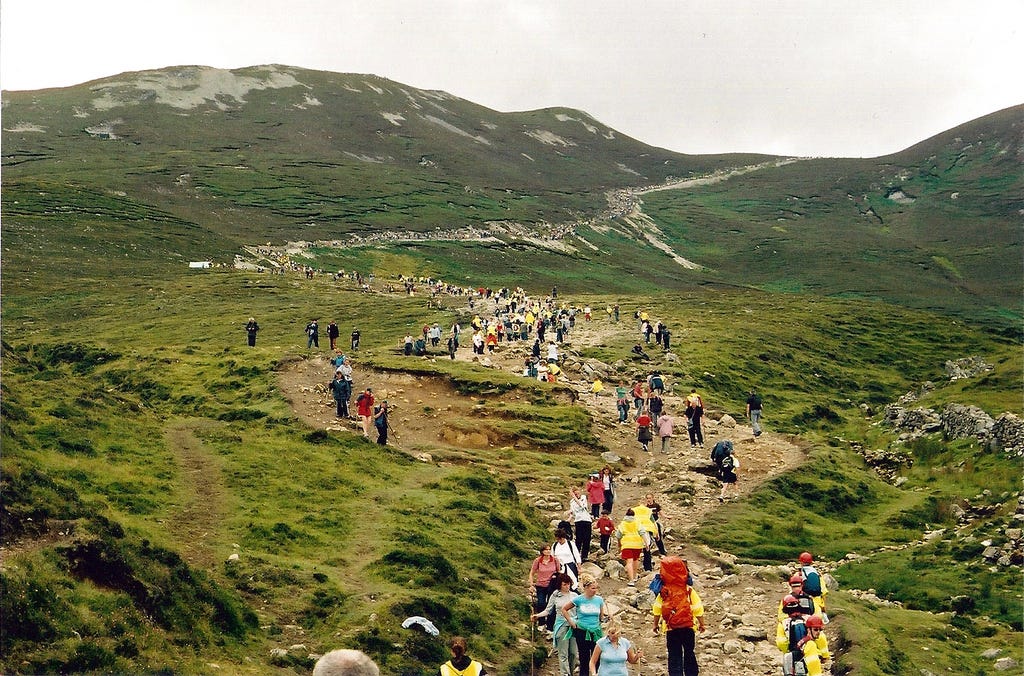 Pilgrims on Croagh Patrick in County Mayo, Ireland. The Civil Defence wearing the red helmets. Alan James CC BY-SA 2.0