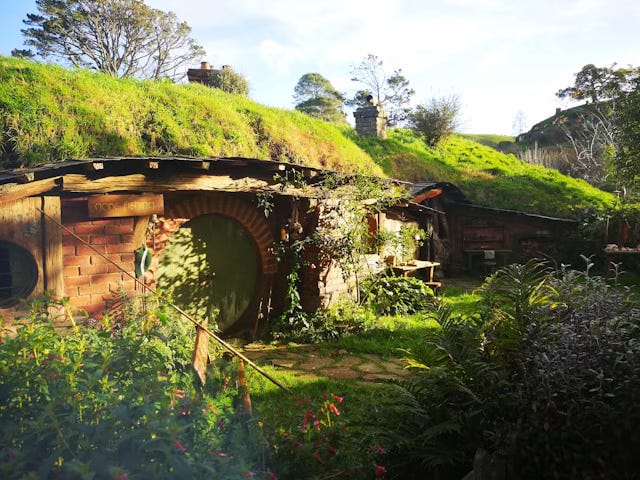 A photograph of a hobbit hole and front garden from the filming location in New Zealand.