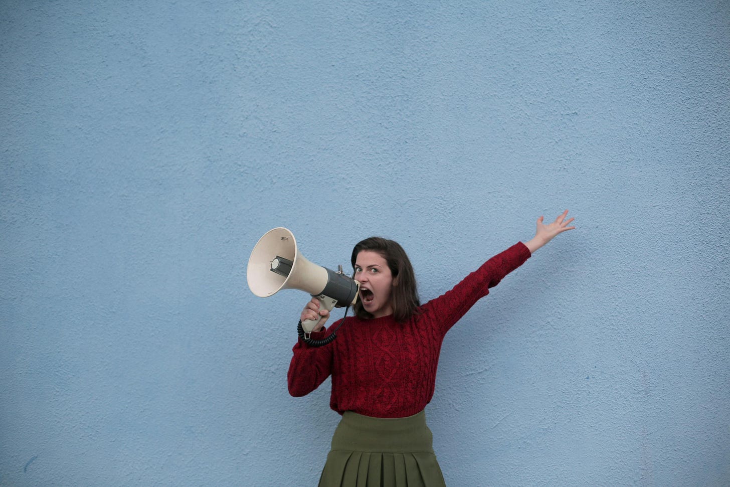 Angry Woman Yelling into a Megaphone · Free Stock Photo