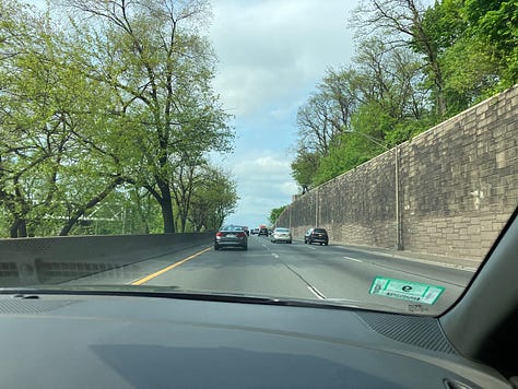 from left to right: first two pics are from the front passenger seat of a car, driving into NYC in the spring time.  You can see new leaves sprouting on the trees.  One picture shows a bit of city skyline off to the side.  The third pic is me, a white female with brown hair, sitting in a lobby wearing a 3M aura.
