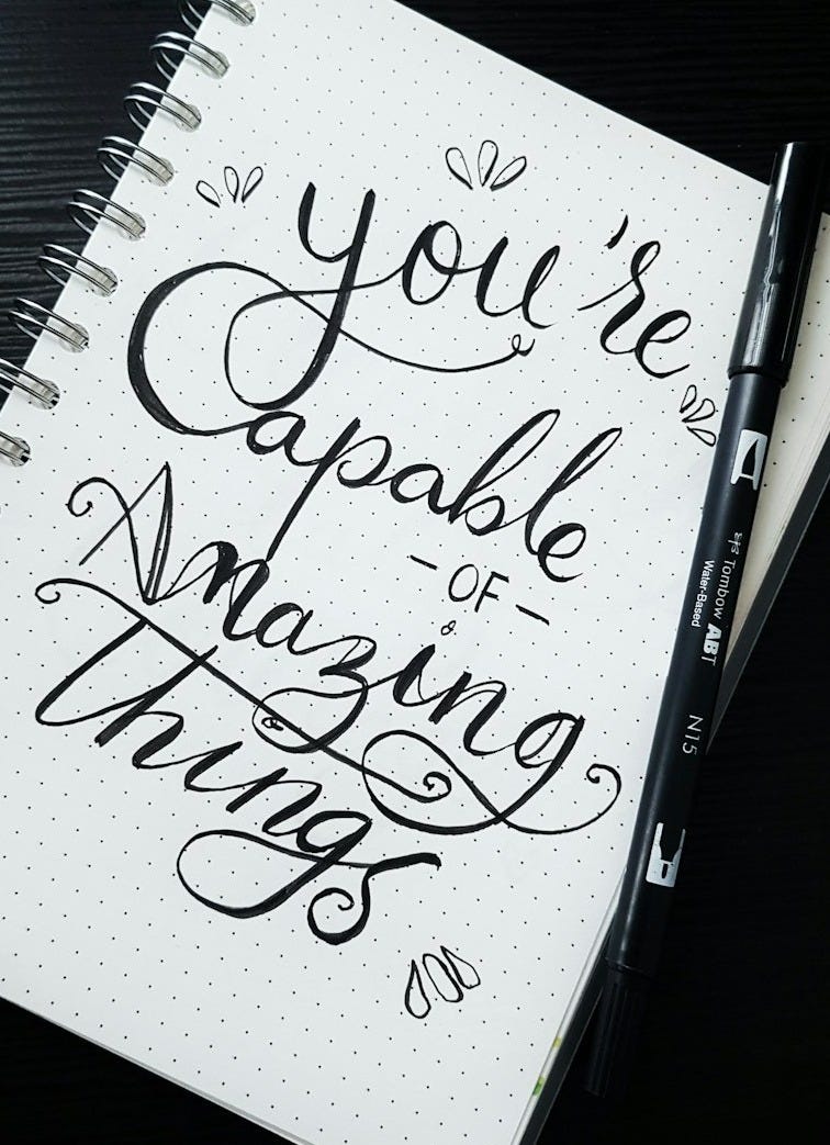 pen on you're capable of amazing things spiral notebook pen on you're capable of amazing things spiral notebook