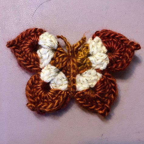 Nine multi-coloured crocheted butterflies