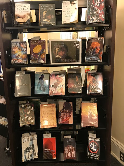 Displays of books including themes like "Black Joy," "Black Future Month," "Graphic Novel Black History Month," "All You Need Is Love?" and "Fighting Together Is Greater Than Fighting Each Other"