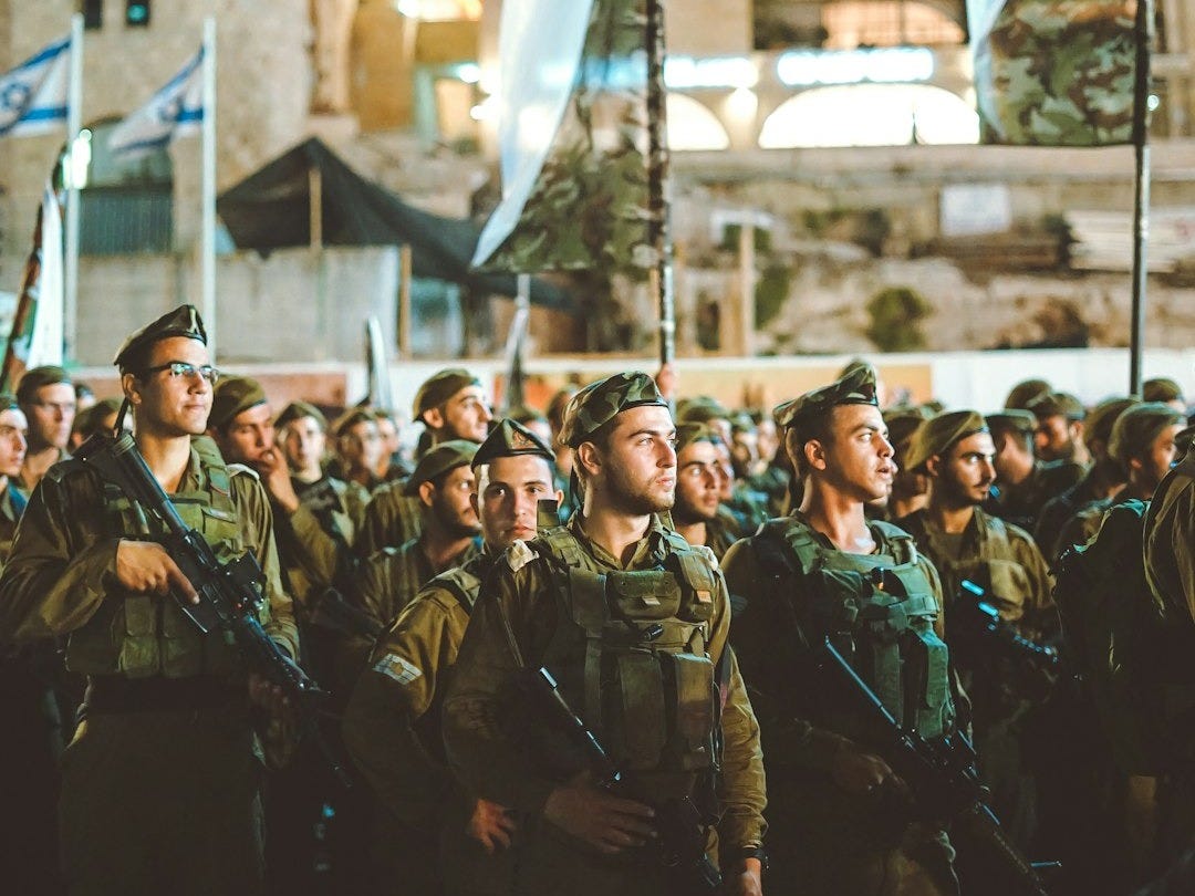 group of armed men with white flag