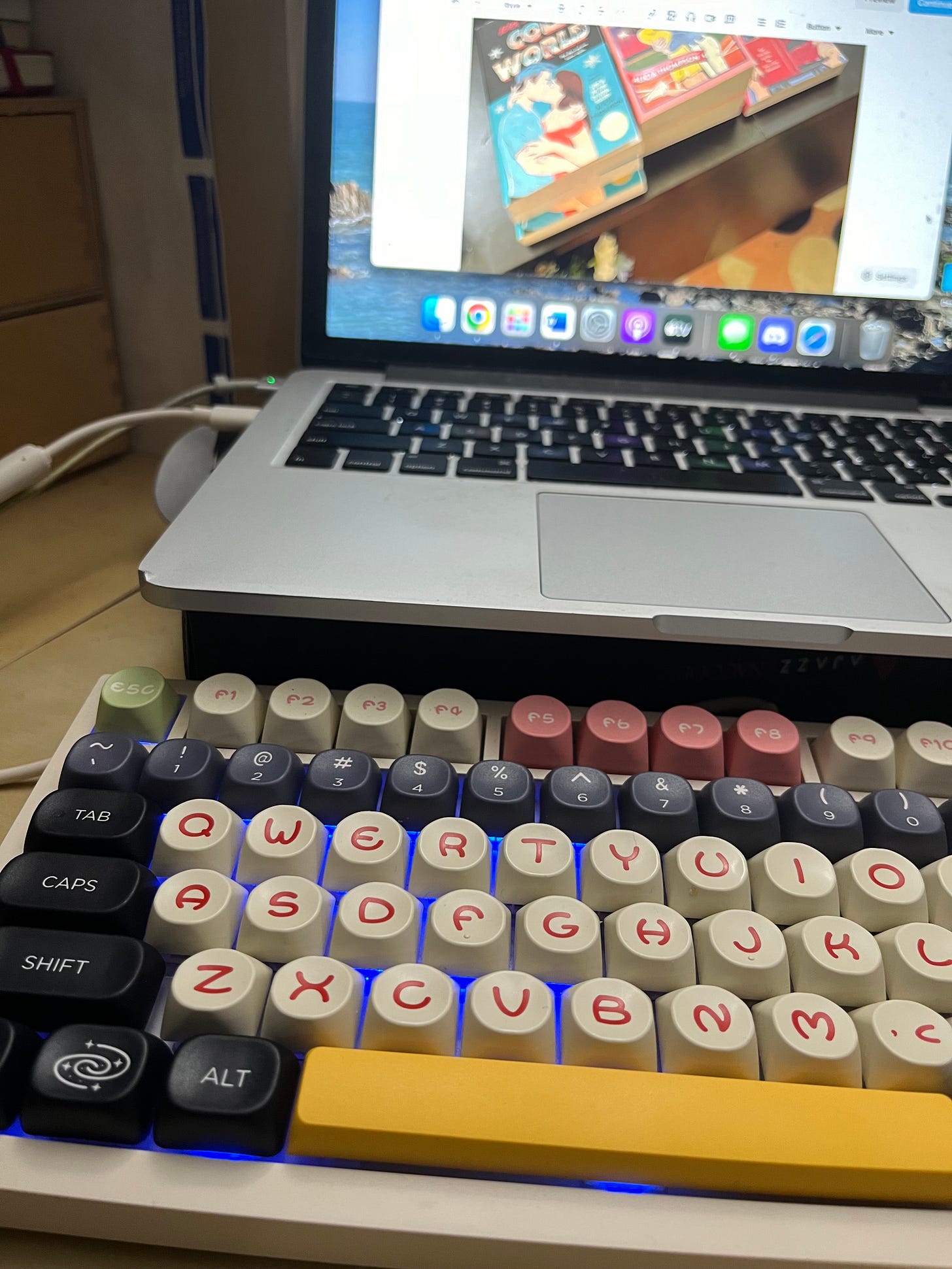 Photo of my laptop set up to show me working on this newsletter with the custom keyboard Susan built for me set up in front of it.