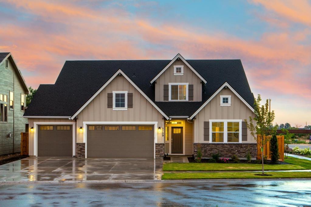 brown and gray painted house in front of road brown and gray painted house in front of road
