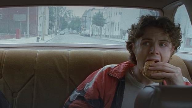 A person eating a hamburger in a car

AI-generated content may be incorrect.