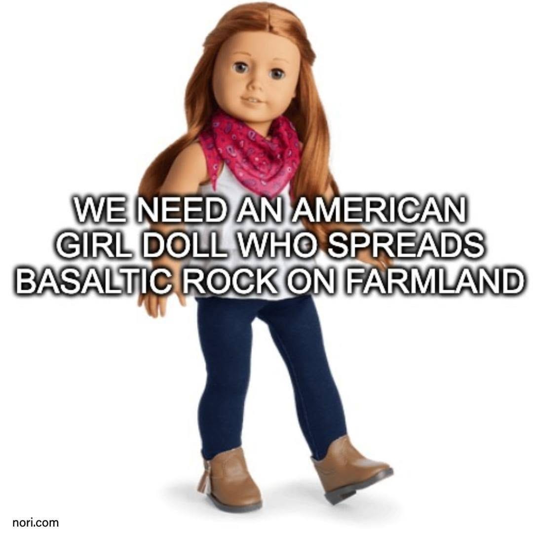 An American Girl doll with red hair, jeans and boots, captioned "We need an American Girl doll who spreads basaltic rock on farmland".
