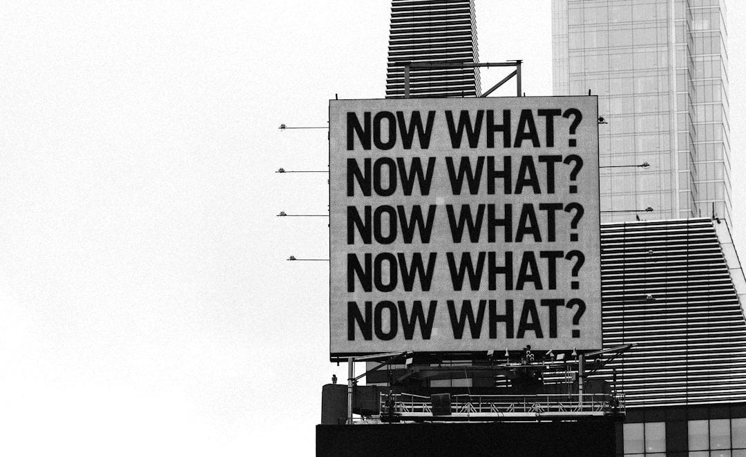 a large blue sign on top of a tall building