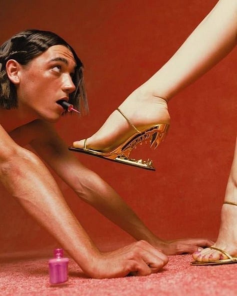 Three stylized studio portraits against vivid orange-red backgrounds: on the left, a person with long black hair covers another person’s eyes from behind; in the center, a person with red rope wrapped around their eyes and mouth; on the right, a person crouches while a high-heeled shoe presses against their open mouth, with a small pink bottle on the floor nearby.