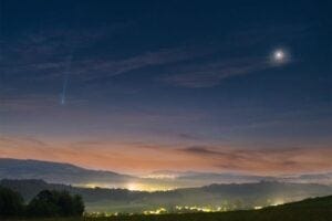 This scene would be beautiful even without the comet. By itself, the sunrise sky is an elegant deep blue on high, with faint white stars peeking through, while near the horizon is a pleasing tan. By itself, the foreground hills of eastern Slovakia are appealingly green, with the Zadňa hura and Veľká hora hills in the distance, and with the lights of small towns along the way. Venus, by itself on the right, appears unusually exquisite, surrounded by a colorful atmospheric corona. But what attracts the eye most is the comet. On the left, in this composite image taken just before dawn yesterday morning, is Comet Nishimura. On recent mornings around the globe, its bright coma and long ion tail make many a morning panoramic photo unusually beautiful. Tomorrow, C/2023 P1 (Nishimura) will pass its nearest to the Earth for about the next 434 years.