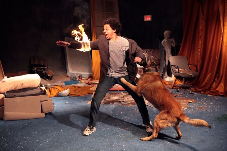 This may contain: a man is playing with his dog on stage