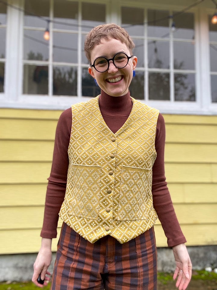 Me, a white woman with short hair and glasses, wearing a gold vest