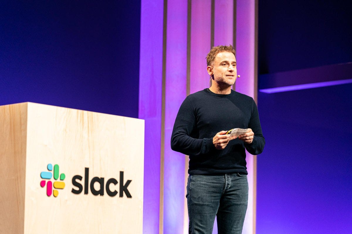 Stewart Butterfield on stage with the Slack logo Stewart Butterfield on stage with the Slack logo