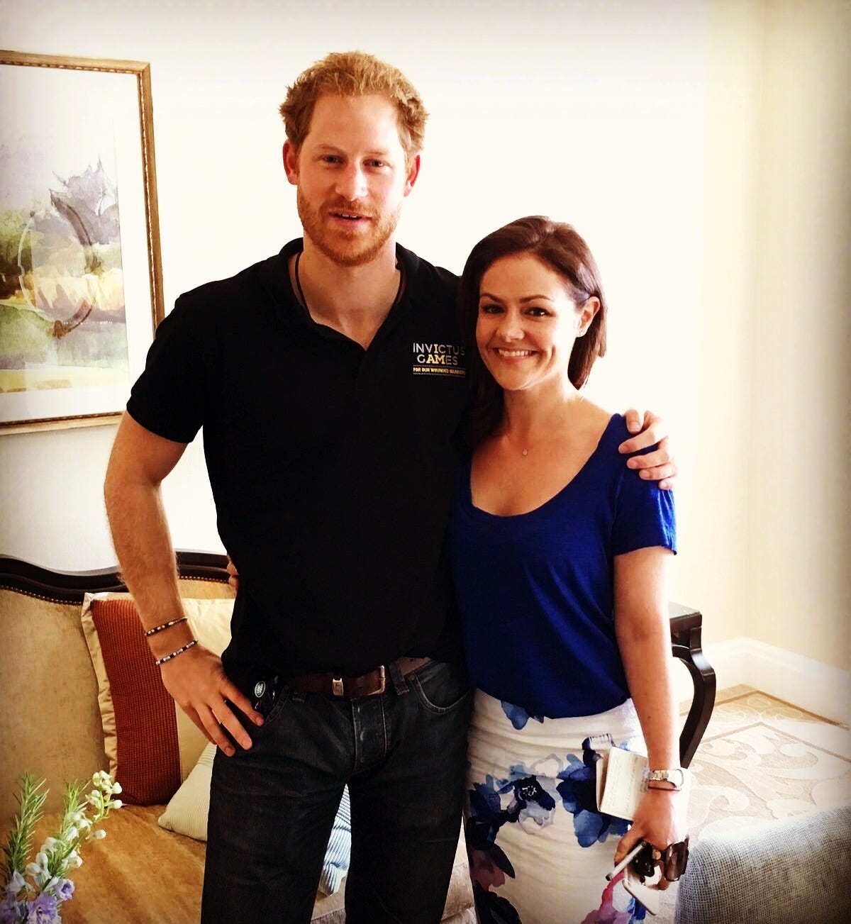 Prince Harry with arm round a smiling Emily Nash
