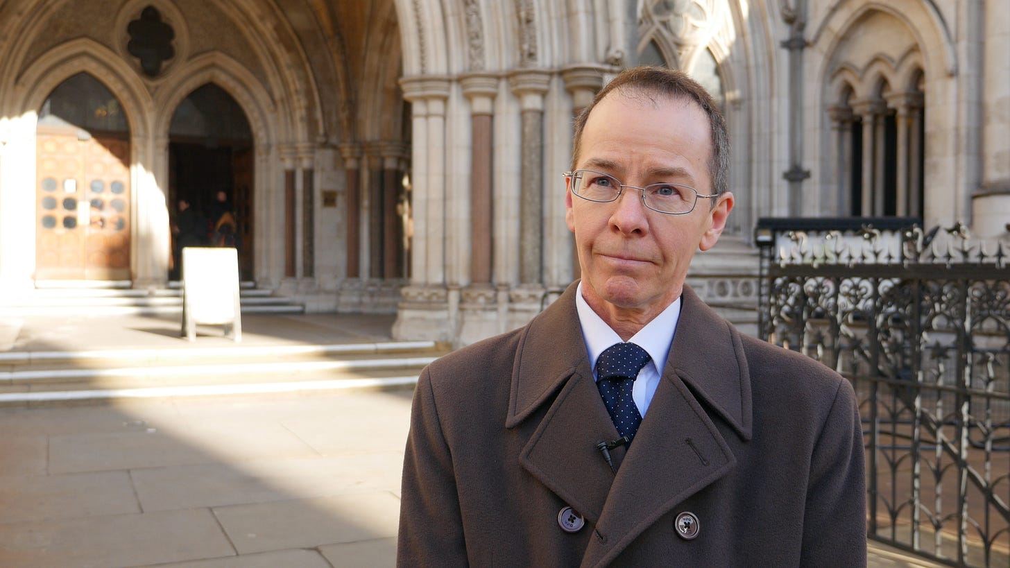 James Caspain - a man standing outside an historic building. James Caspain - a man standing outside an historic building.