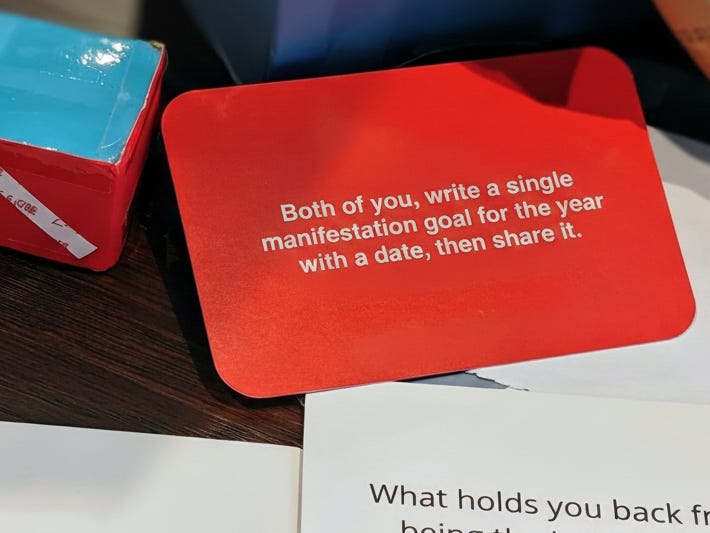 A striped dice next to an action card with a meaningful challenge.