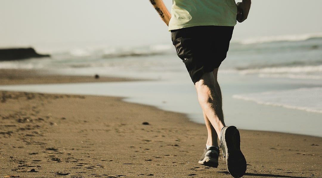 man running on seashore
