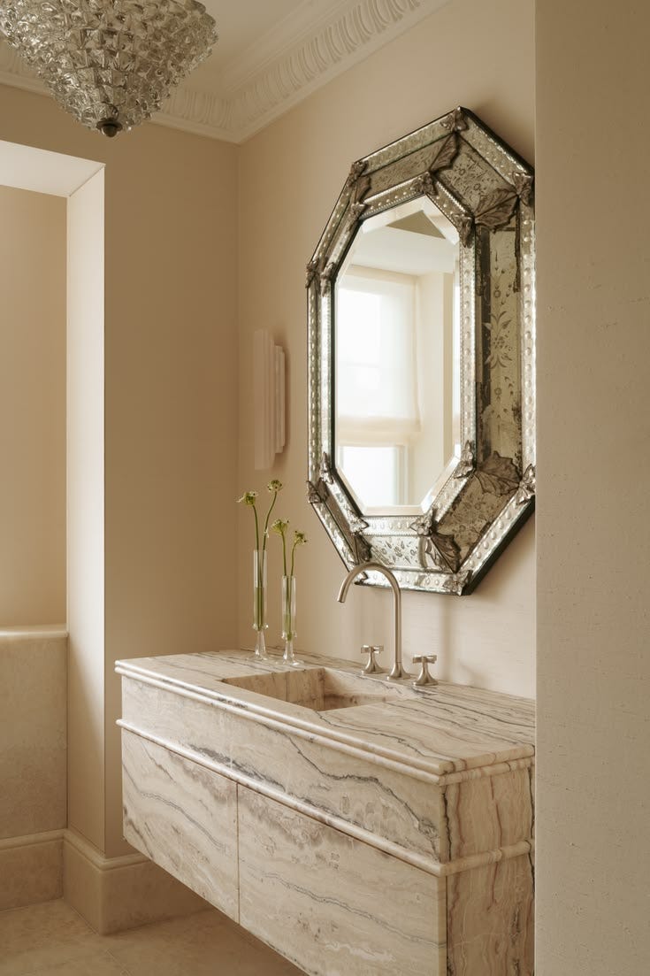 This may contain: a bathroom with a marble sink and mirror