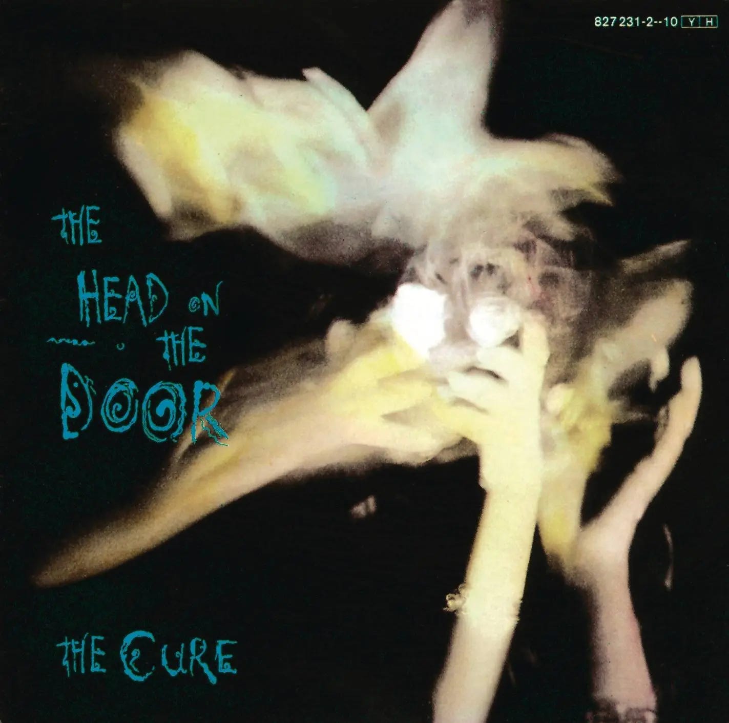 Album artwork for The Cure’s The Head on the Door, showing a blurred, ghostly figure holding their head against a dark background, used in the Callie Kazumi Tarot DMs interview.