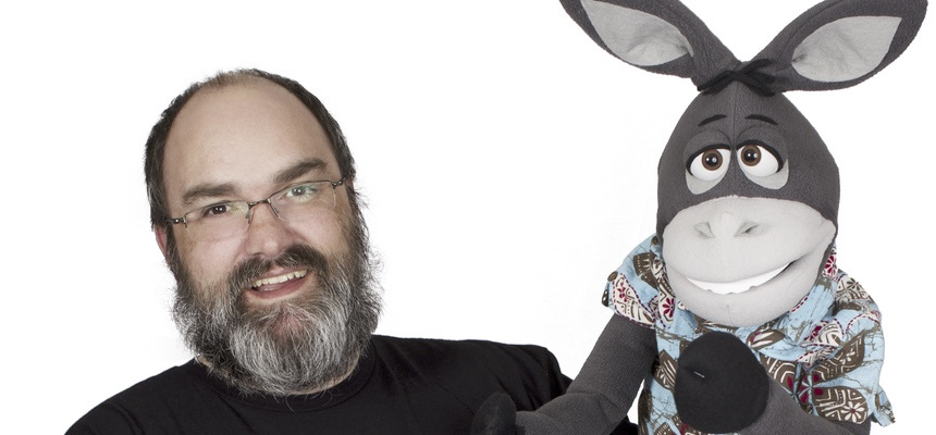 Christopher L. Jorgensen holding Hoté the donkey puppet.