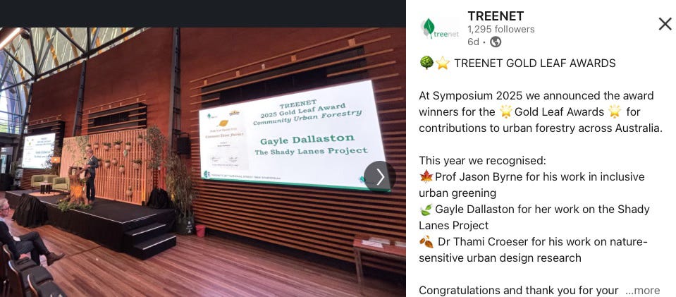 conference speaker on stage with large screens at the sides