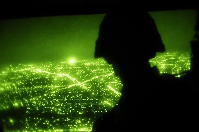U.S. Army Sgt. John Butler of the 11th Psychological Operations Task Force observes Sadr City, Baghdad, from a UH-60 Black Hawk during a leaflet drop on October 2, 2008. U.S. Army Sgt. John Butler of the 11th Psychological Operations Task Force observes Sadr City, Baghdad, from a UH-60 Black Hawk during a leaflet drop on October 2, 2008.