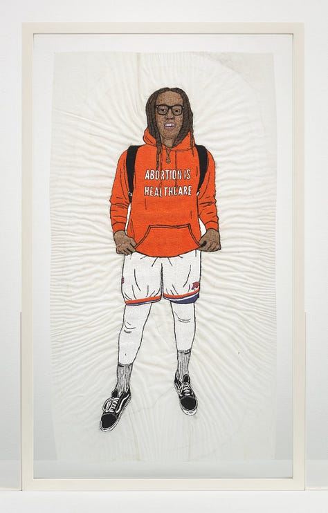 1 - 2) Brittney Griner's portrait is seen fron the front view. In it, she is wearing an orange hoodie that says 'Abortion is healthcare'. She has dreads, some of which are tucked into her hoddie, and she is wearing white shorts, and white leggings underneath. She has on black sneakers, and black backpack straps on her shoulders. She also has thin-framed black square glasses on. 3) The verso side of the embroidery is seen with different messages attached, and messy stringwork. 4) A close-up of the verso side shows some of the texts strings on black fabric like 'Brittney Griner', 'Two-time olympic gold medalist', and 'NCAA Final Four'. 5) The front of the portrait is seen at a gallery, surrounded by two other works on eithe side. It's sitting on a tall white pedestal. The gallery's walls are white, with black stone flooring.