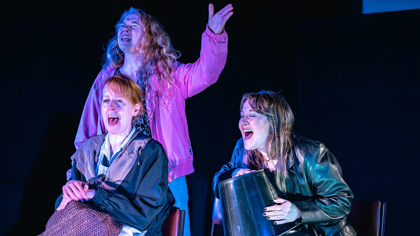 Three women and a donations bucket