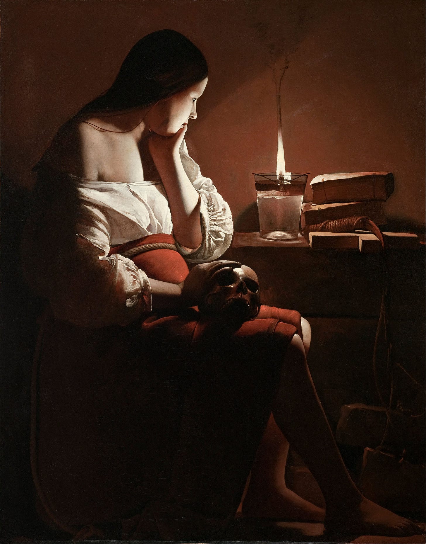 Mary Magdalene seated at night with a hand resting on a skull