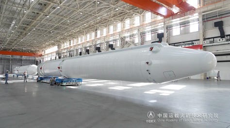 The vehicle's boosters being prepared for flight (left), the first and second stages heading to the launch pad (center), and teams preparing to lift the rocket's fairing (right).
