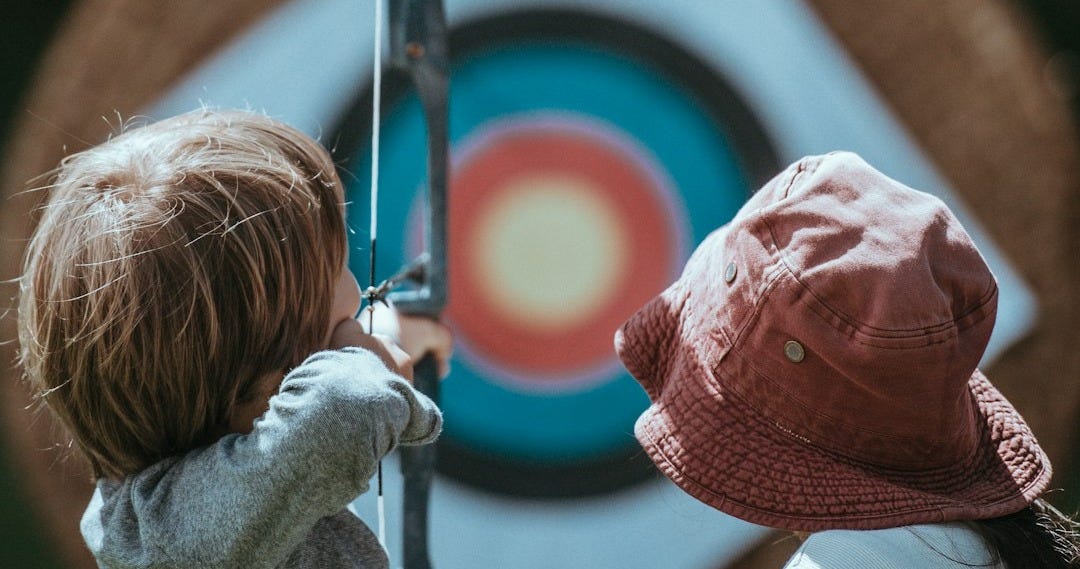 two child playing arrow