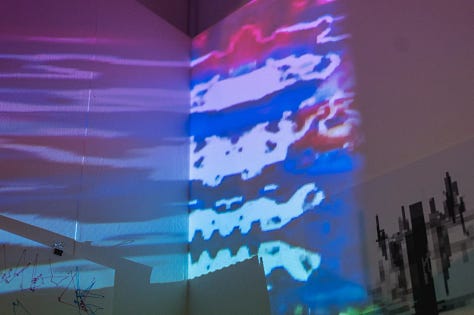 Images of performances in gallery space with artists using various types of sound and projection equipment  